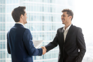 Franchise buyer and consultant shaking hands after choosing the right franchise opportunity